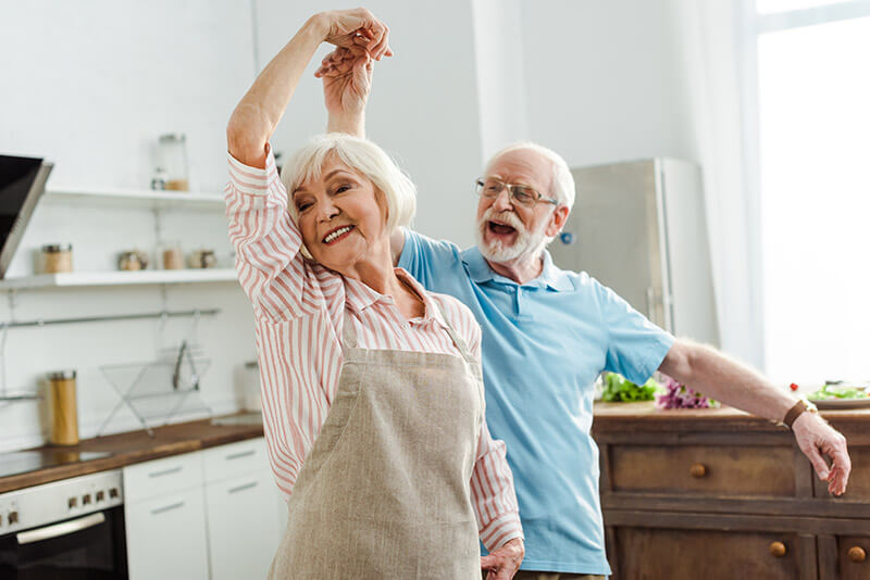 Zwei Senioren tanzen in der Küche